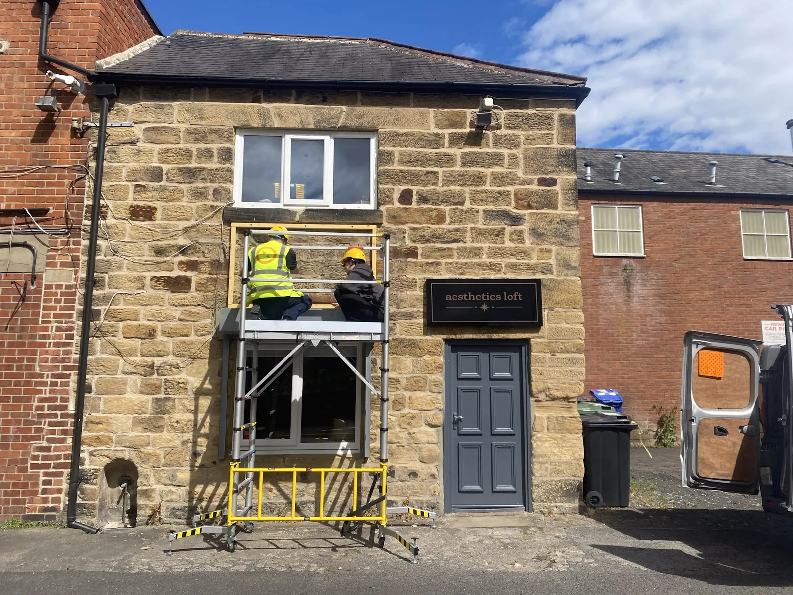 NBNE fitting the Hair Inc fascia from a scaffold tower